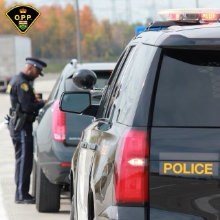 Police officer examining a vehicle.