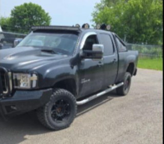 Black pickup truck with lifted suspension and accessories