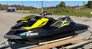 Black and yellow jet ski on a trailer. ON 3862494