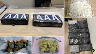 Stacked bundles of cash Small bag of white pills Multiple bags of a green substance 