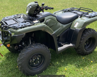 Green four-wheeler with black tires
