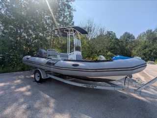Gray inflatable boat on a trailer.