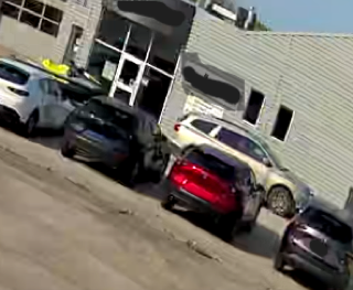 Several cars parked outside a building