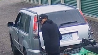 Person loading items into a silver SUV; license plate CHZ-325