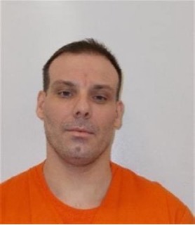 Man with short dark hair and an orange t-shirt.