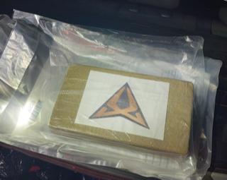 A logo of a stylized triangle inside a clear plastic bag.