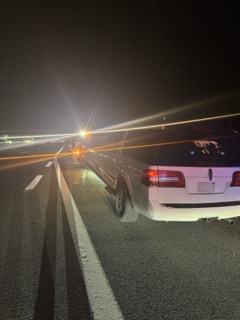 White SUV on a highway at night