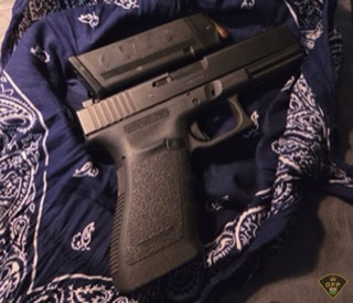 Black handgun on a blue bandana