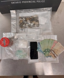 Stacks of Canadian twenty-dollar bills and a small jar of Tostitos salsa.