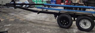 Blue trailer frame with two tires