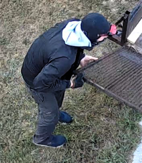 Person inspecting a grill