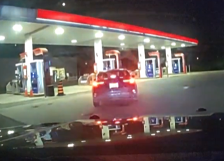SUV at a gas station at night