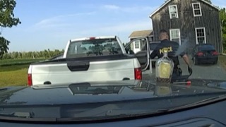 White pickup truck, man holding bottle, smoke rising