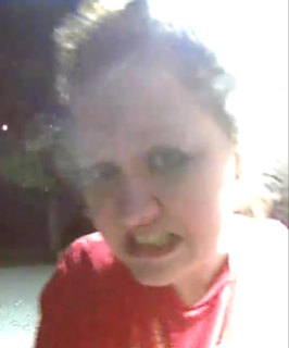 Person smiling broadly, red shirt