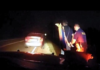 Police officer assisting a person with a possible injury.