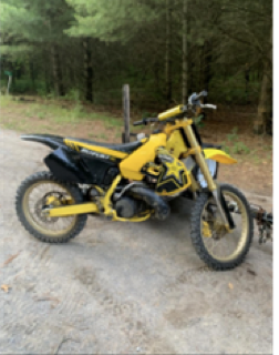 Yellow dirt bike on gravel road