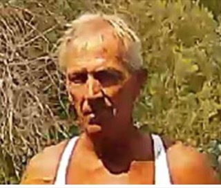 Older man with short gray hair, looking distressed