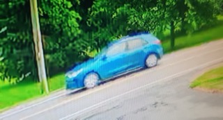 Blue car speeding on a road