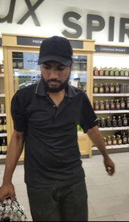 Man in black shirt and black baseball cap