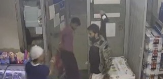 Three people near a door.