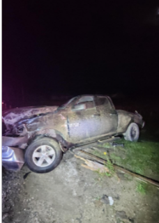 Damaged pickup truck in tall grass