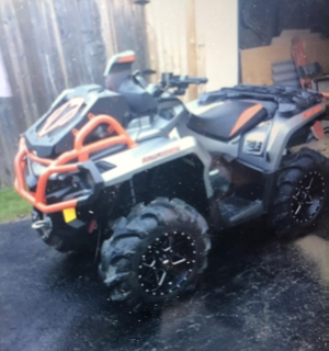 Orange and black ATV with large tires