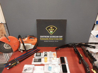 Stihl chainsaw, multiple hand tools, cell phones, packages of drugs, OPP logo, Southern Georgian Bay Community Street Crime Unit, Ontario Provincial Police
