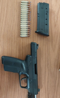 Black handgun and magazine with ammunition