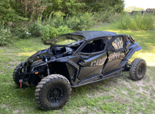 Black Can-Am side-by-side ATV on grass