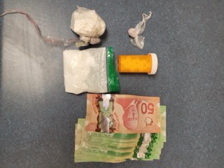 Canadian banknotes and small plastic baggies, orange pill bottle