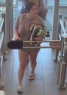 Person holding flowers, walking through turnstile