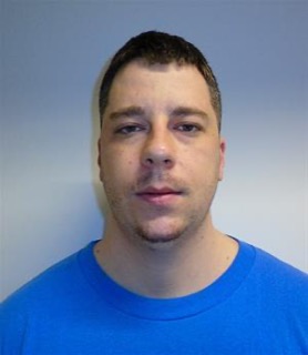 Man with short dark hair, blue t-shirt