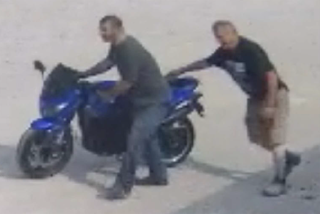 Blue motorcycle, two men
