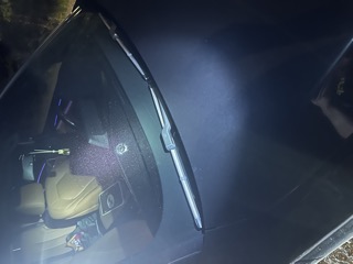 Interior of a car, windshield wipers visible