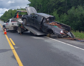 Damaged pickup truck on a tow truck.