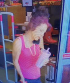 Person holding a clear plastic cup with a straw