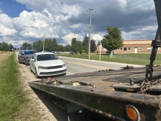 White sedan on a tow truck.