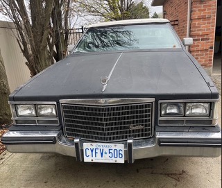 Black Cadillac with chrome trim, Ontario license plate CYFV 506