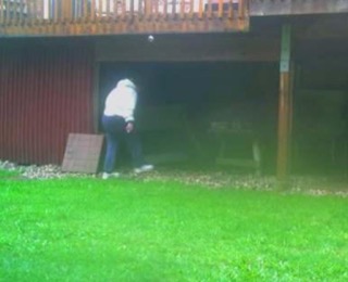 Person standing near a red building