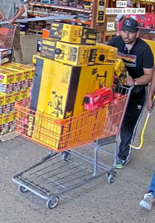Man pushing a shopping cart full of tool boxes