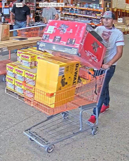 Man pushing a shopping cart full of tool boxes