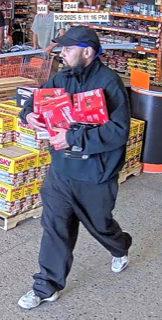 Man carrying red boxes, wearing a black hoodie and sneakers