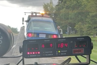 Police car with visible dashboard display showing "184"