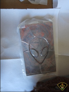 Black packaging with a red alien graphic.