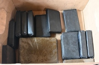 Several packages wrapped in black plastic.