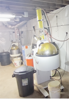 Industrial machinery and containers in a warehouse.