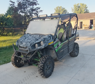 Black and green camouflage side-by-side ATV with oversized tires