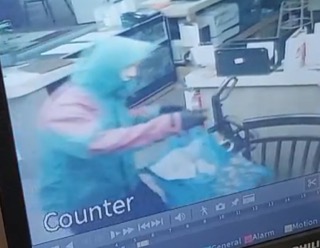 Person wearing a welding mask and gloves