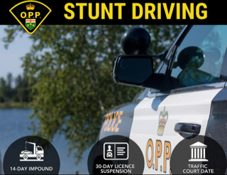 OPP police vehicle, front view, water and trees in background 