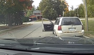 Van with open door, parked on a residential street.